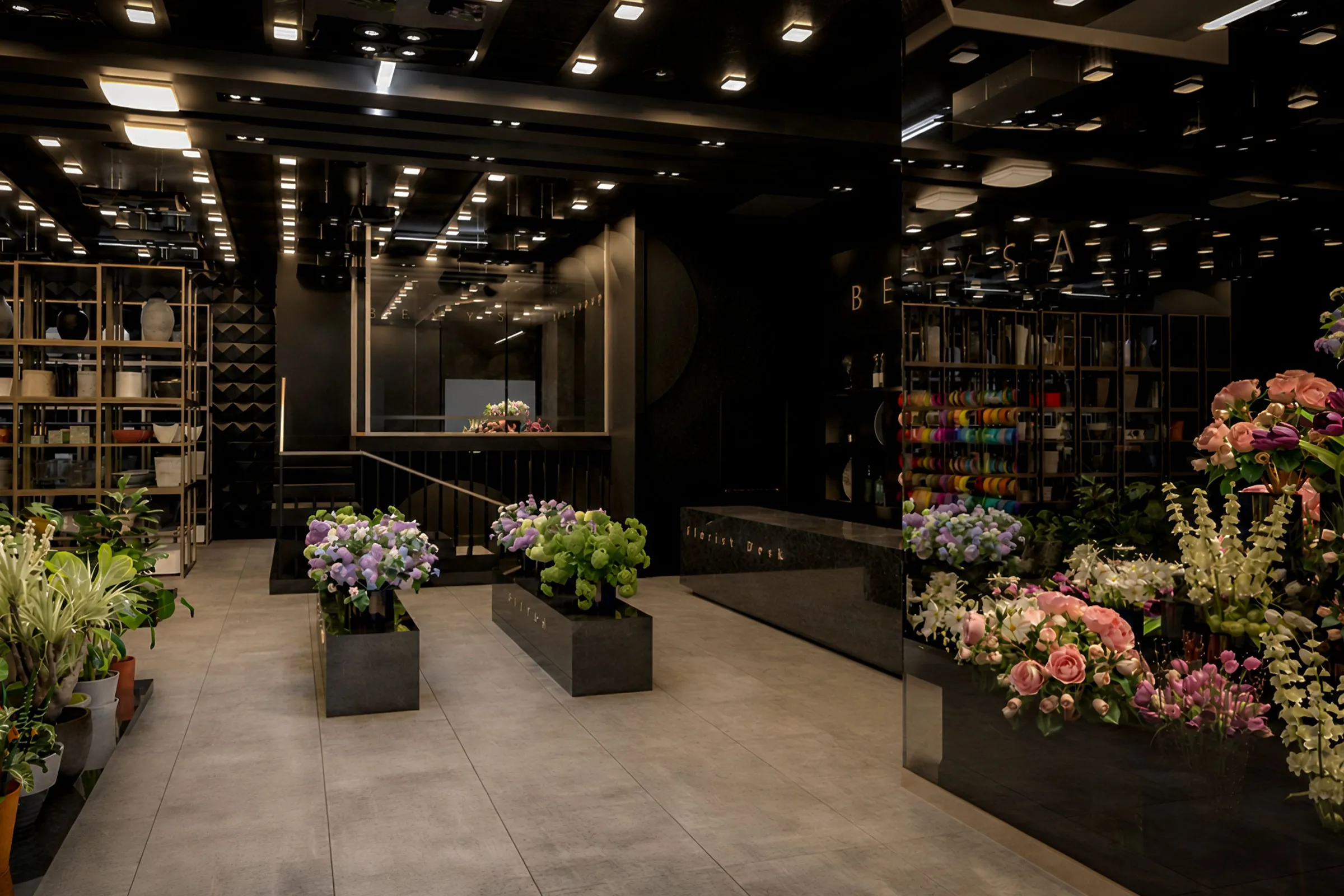 Benisa luxury plant store at Iran Mall with a dark interior, illuminated flower displays, glass showcases and black retail shelving.