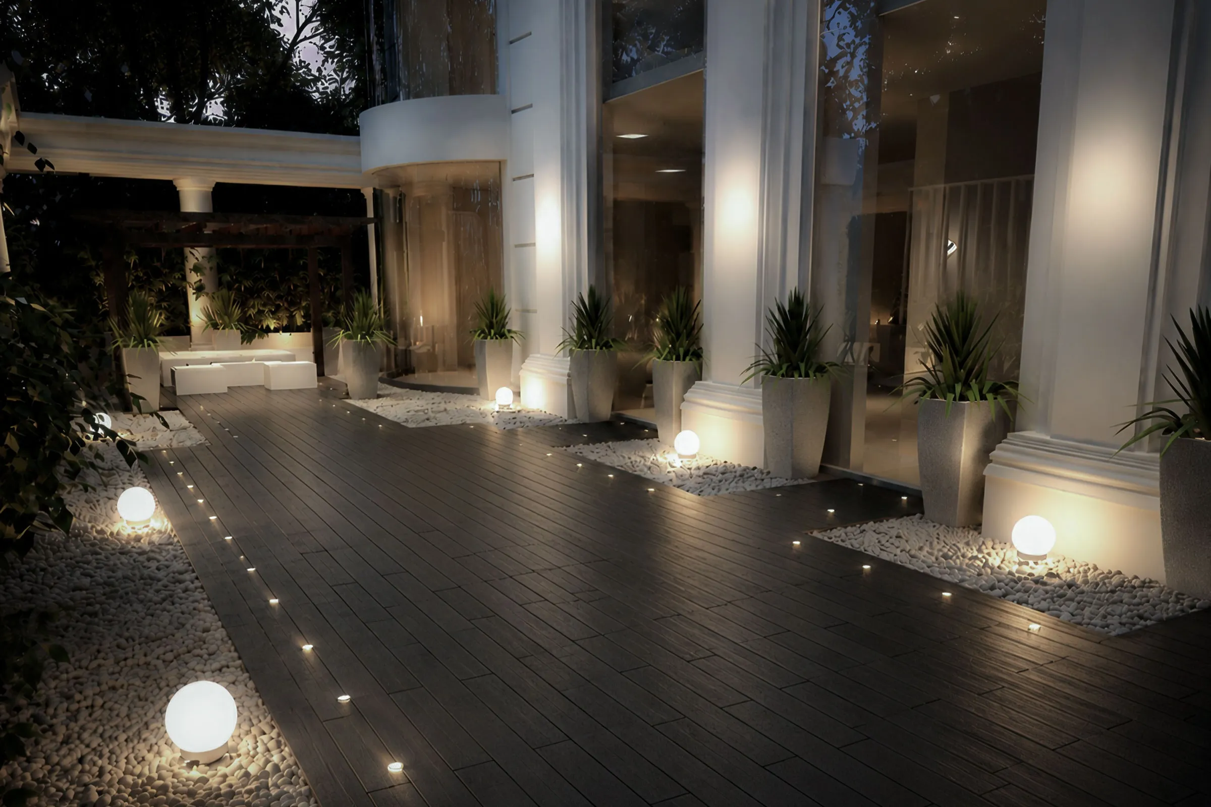 Private Tehran apartment terrace with dark timber decking, classical travertine columns, spherical floor lights and landscaped planters.