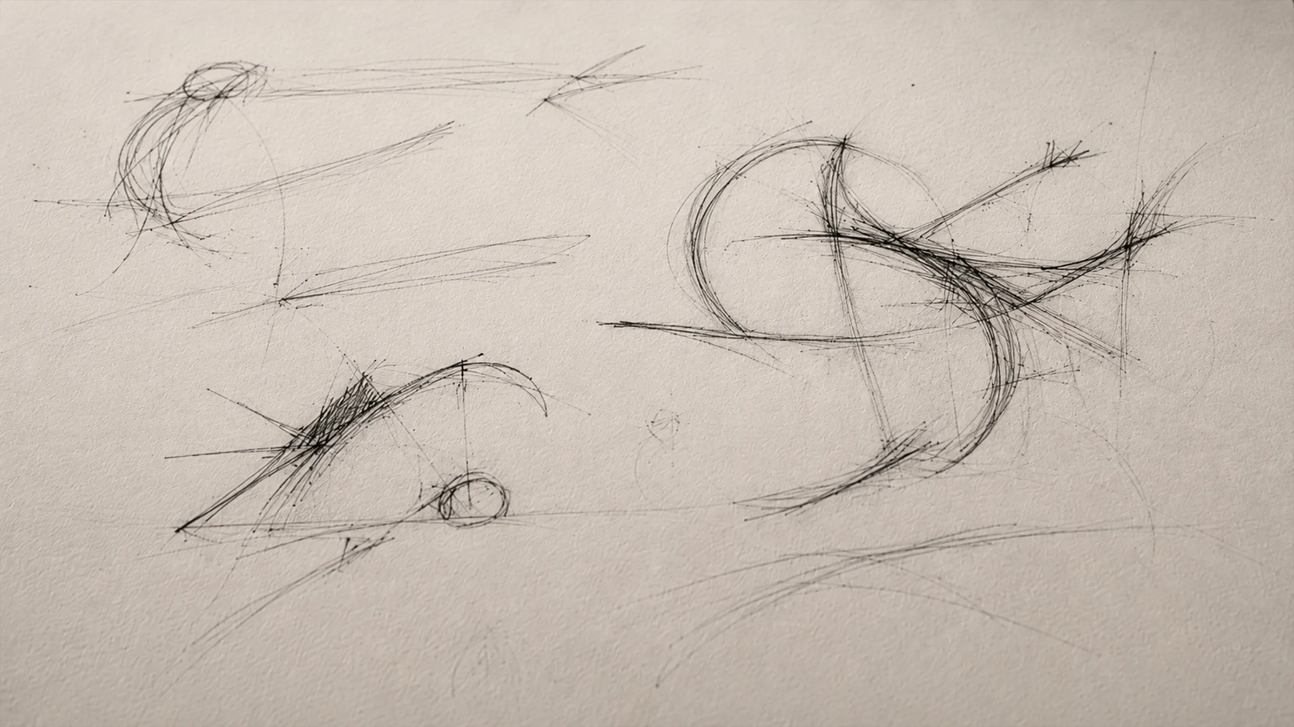Loose black conceptual sketches on textured paper, showing several incomplete forms captured before their final meaning or direction becomes clear.