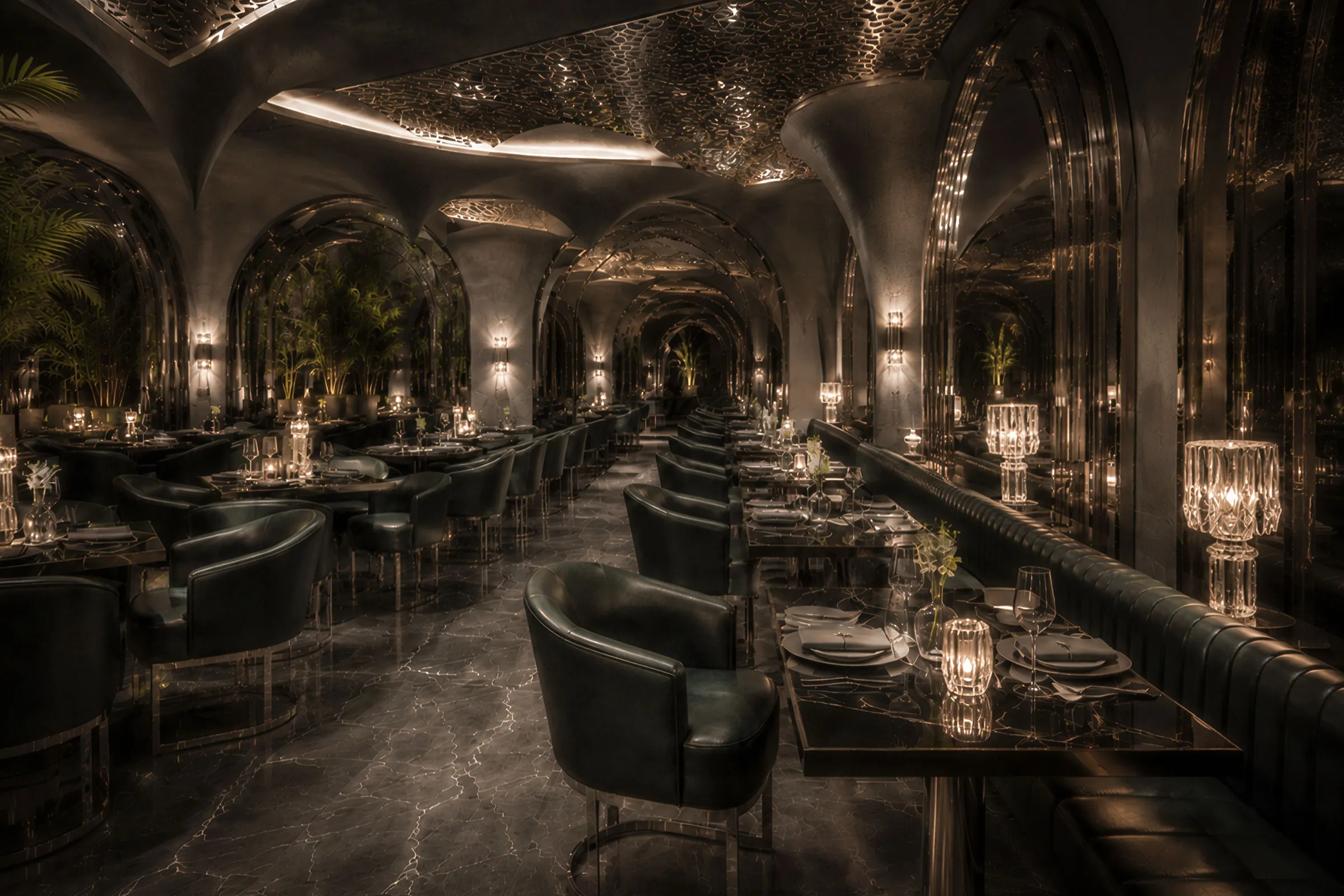 Ornate dark Toranj restaurant interior in Dubai with arched forms, patterned ceilings, mirrored surfaces, candlelight and green dining chairs.